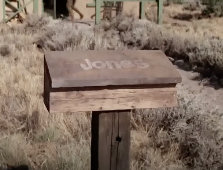 A wooden mailbox with the name &quot;Jones&quot; on it is seen outside a house in Antonito, CO.