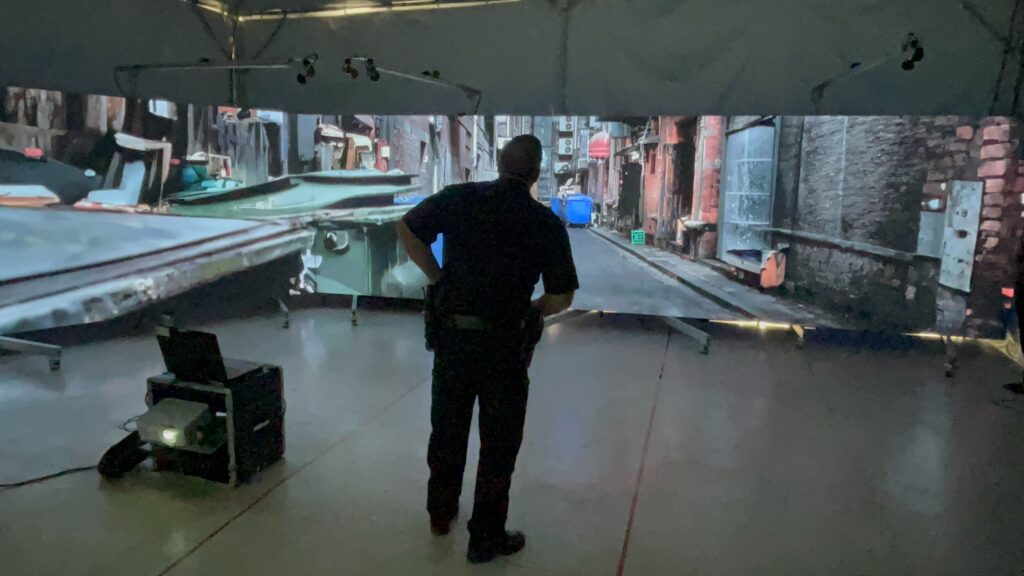 A police officer observes a simulated training