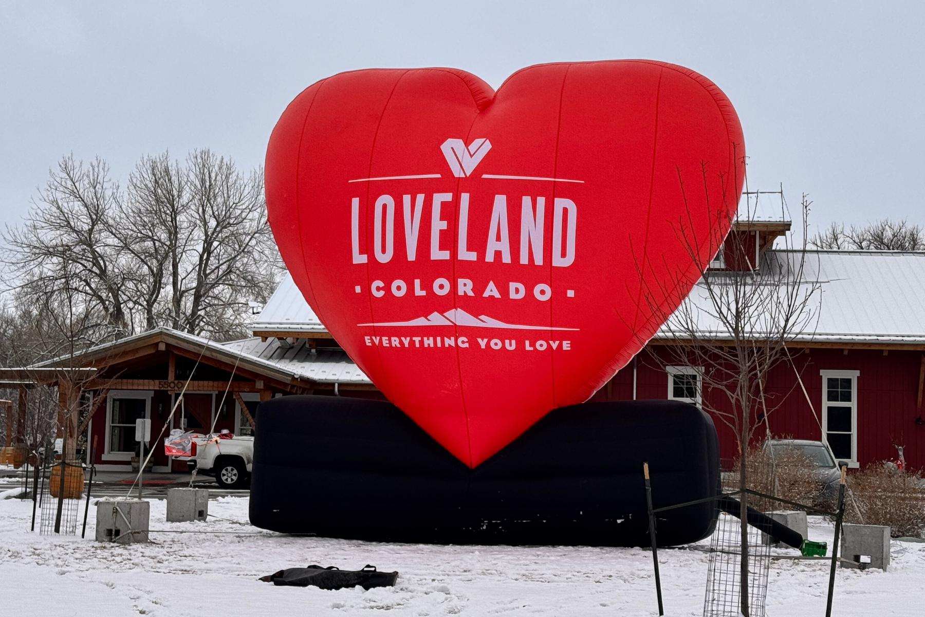 Large inflatable red heart stands amid snow in Loveland, CO