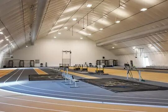 The interior of the Mountain Lion Fieldhouse, with benches and atheltic equipment inside.