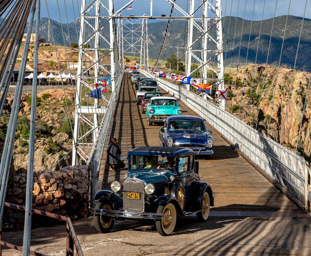 Classic Antique Cars file across the bridge