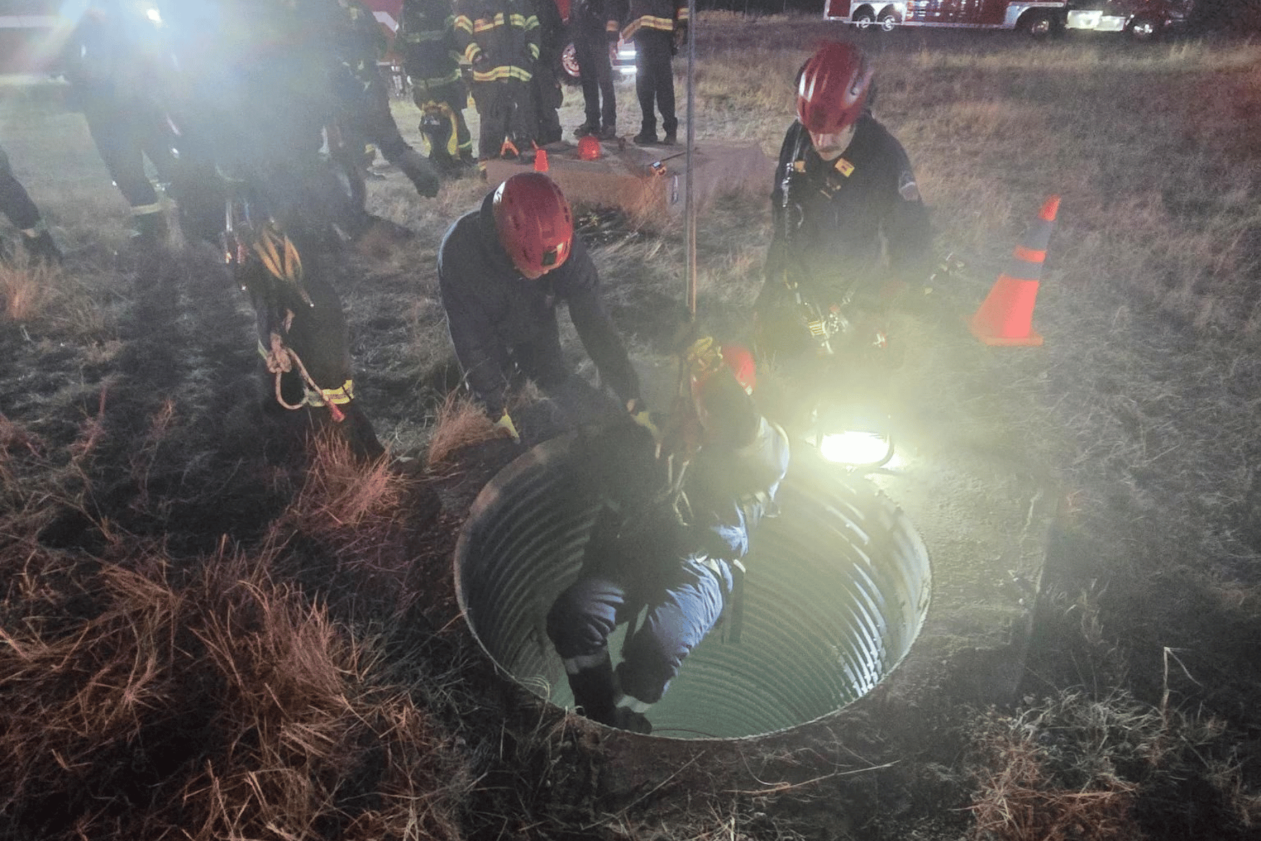 Fire and rescue lowering into a silo to rescue a trapped teen