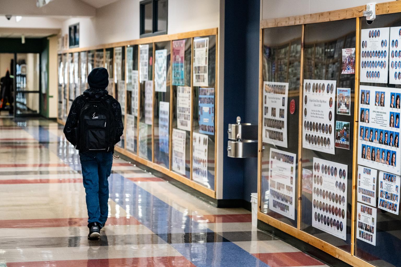 A student walks in a hallway.