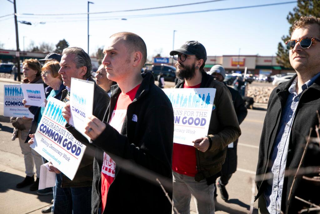 Picketers hold signs outside of an east Denver King Soopers