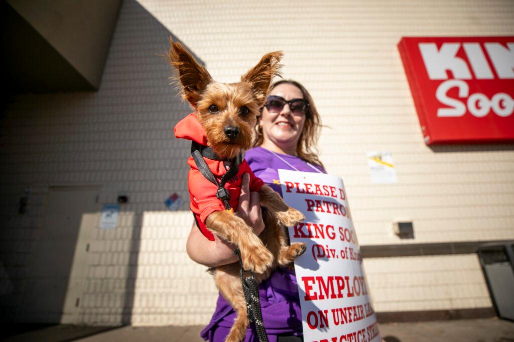 JulieAnna Gonzales and Drako the dog picket outside a King Soopers