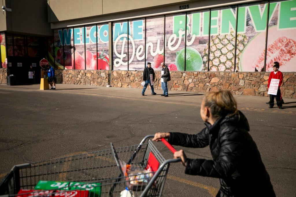 Picketers stand outside of a southwest Denver King Soopers