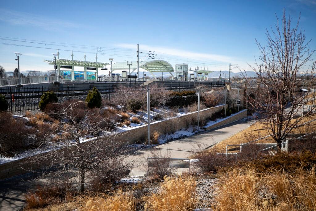 A train station sits near a trail with blue skies in the background.