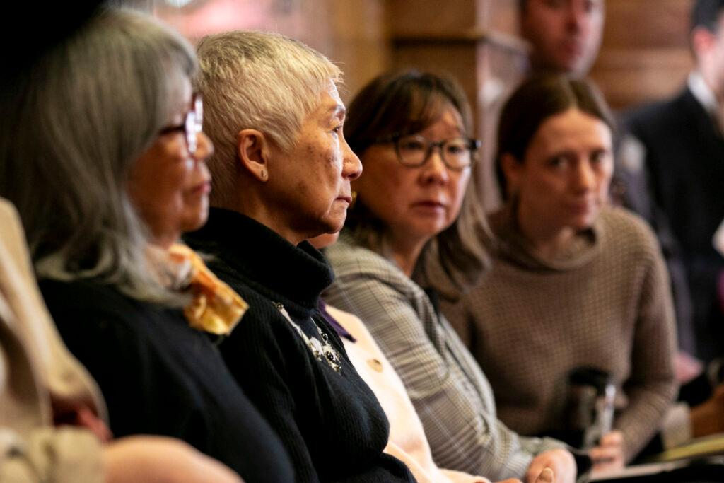 Stella Yu sits with representatives of Colorado's Japanese-American community