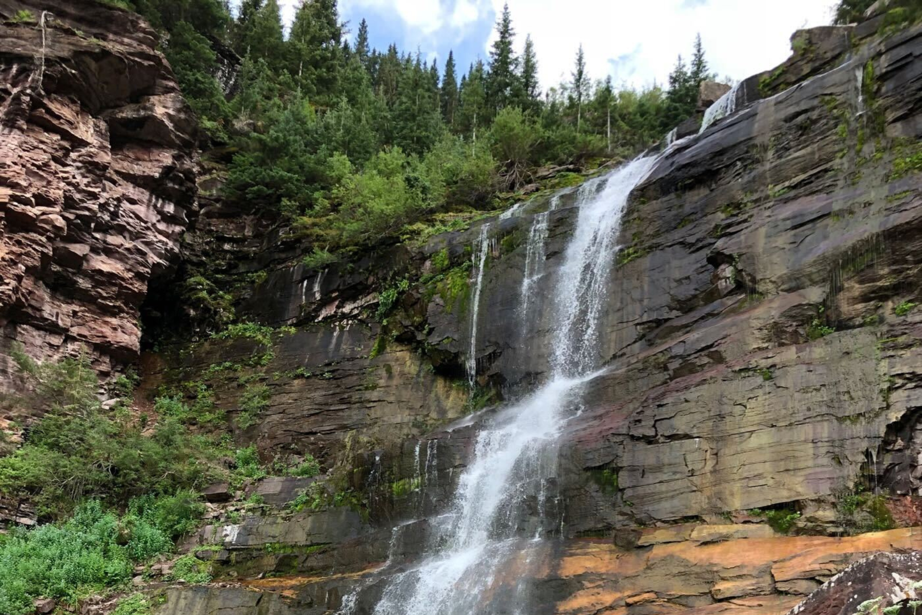 Bear Creek Falls with greenery surrounding the waterfall