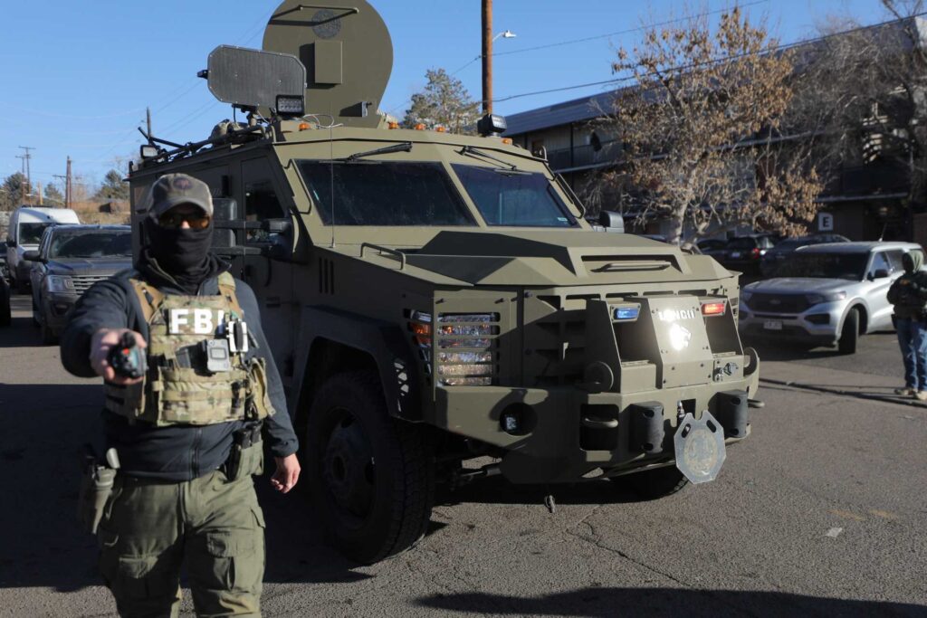 Federal law enforcement with an armored vehicle outside the Cedar Run Apartments