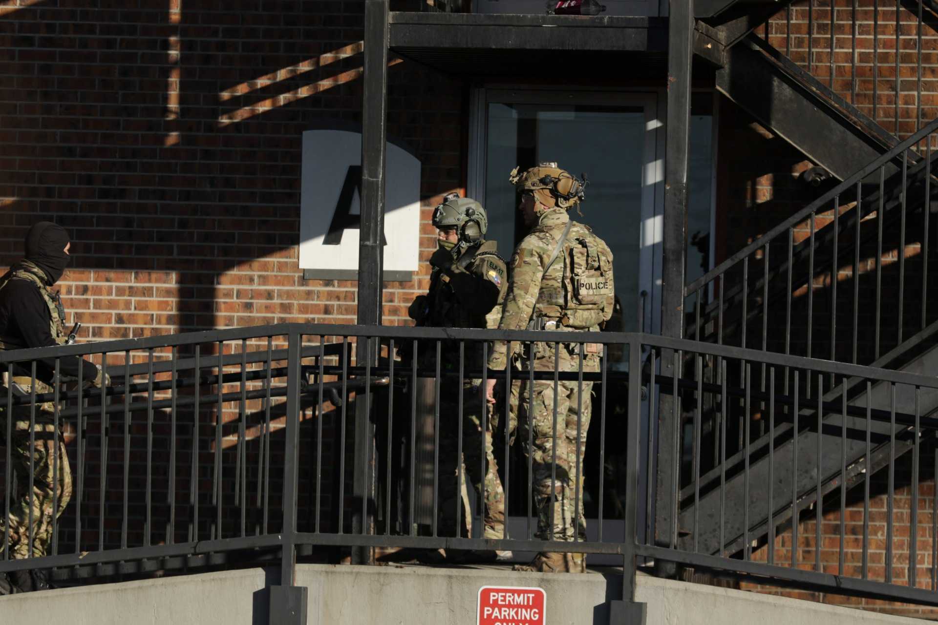 Federal law enforcement outside the Cedar Run Apartments