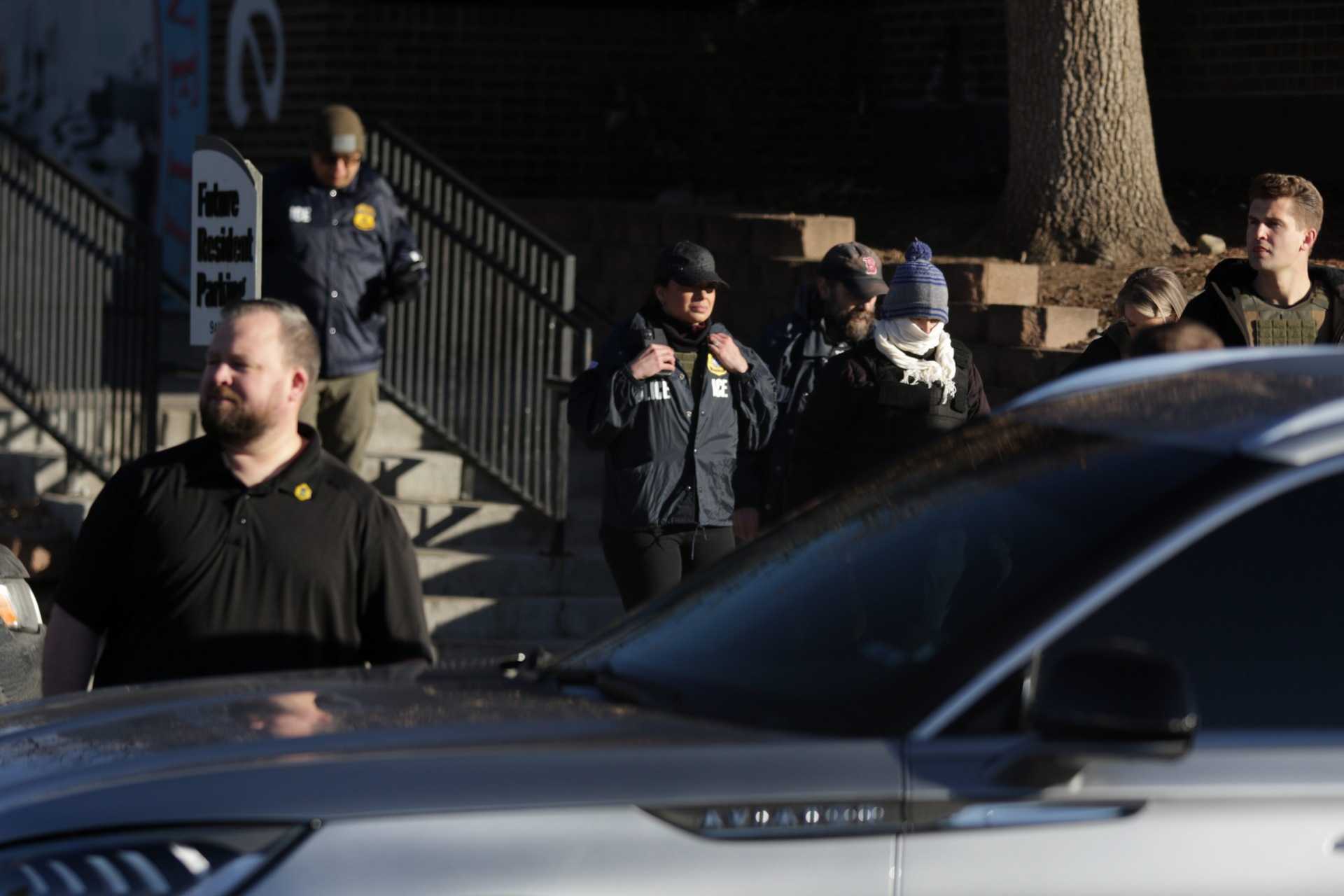 Federal law enforcement outside the Cedar Run Apartments