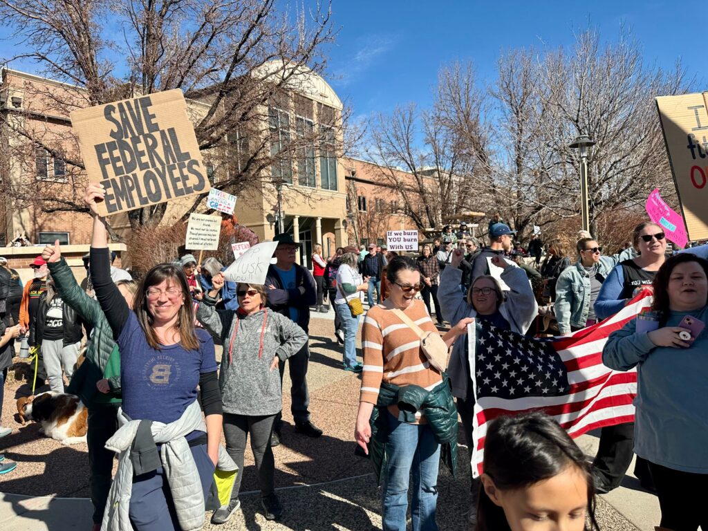 People holding signs gather outside