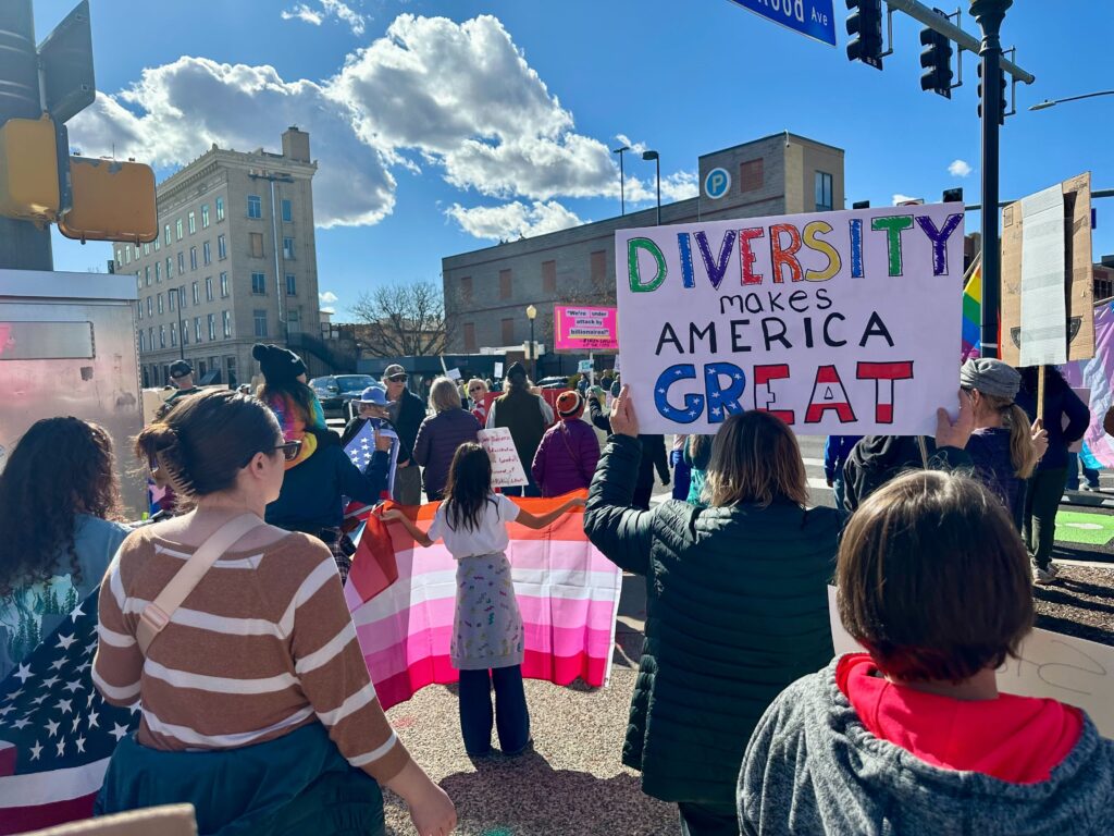 People holding signs gather outside