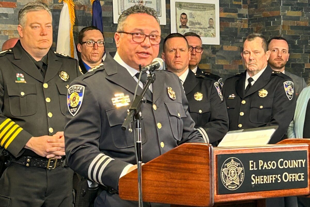 El Paso County Sheriff Joseph Roybal speaks into a microphone at a podium during a news conference.