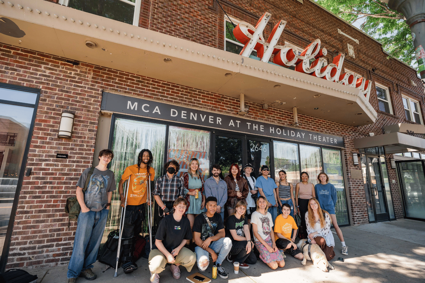 MCA Creator's Studio team gathers for a photo in front of the iconic Holiday Theater building.