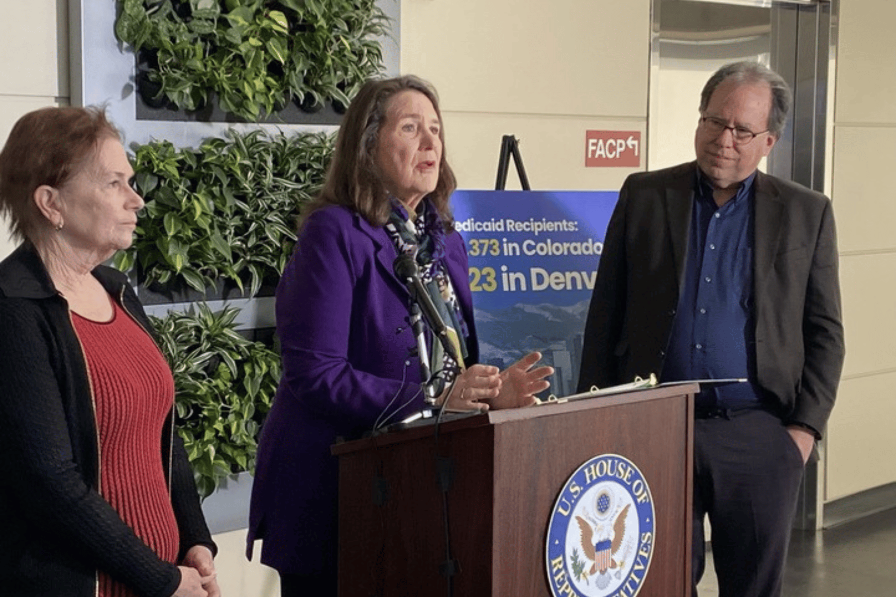 Three people speak during a press conference