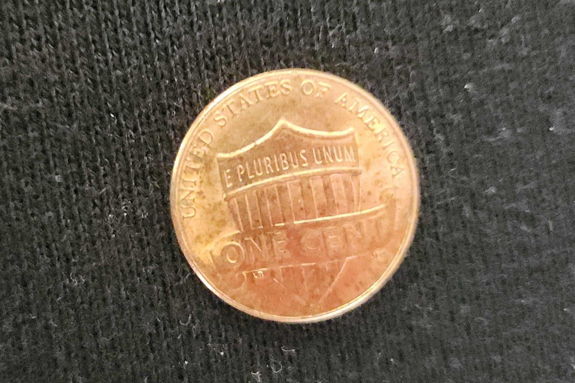 A penny in front of a dark background.