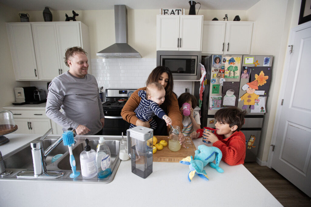 State Rep. Yara Zokaie (center, back) makes lemonade with her family