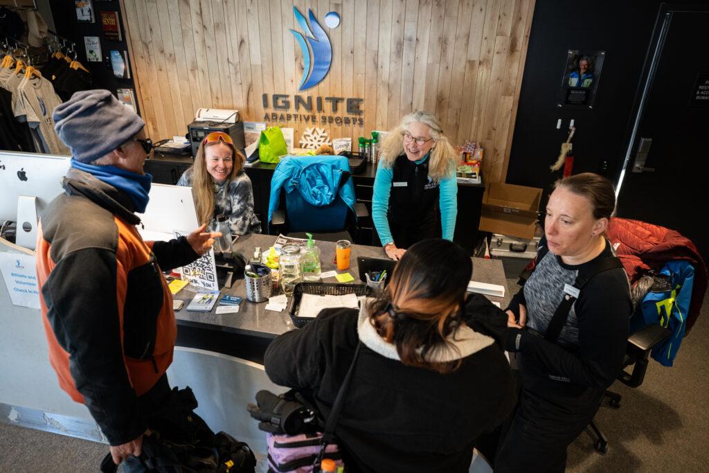 Ignite volunteers greet and check in athletes at the organization’s front desk