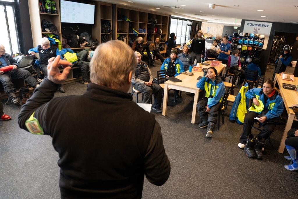 Ignite Adaptive Sports guides listen to a morning briefing