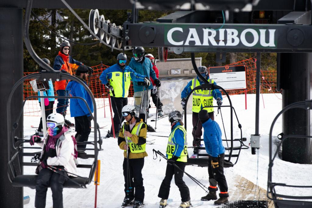 Ignite guides in blue and yellow uniforms, guide their athletes onto the Caribou list at Eldora