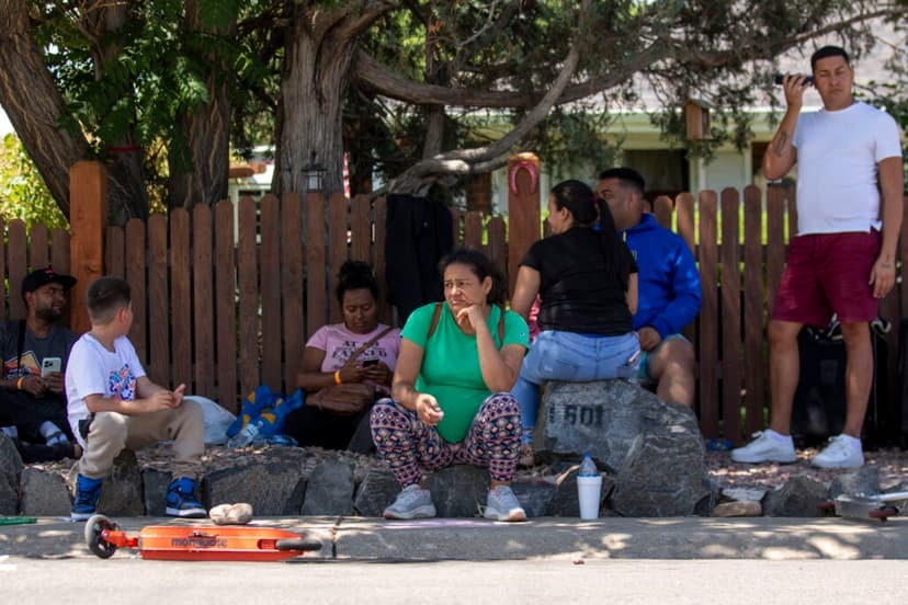 Yubisay Fonesca waits on the curb near the Fitzsimons Place apartment complex, after she was forced to move out of her home there alongside all of her neighbors.