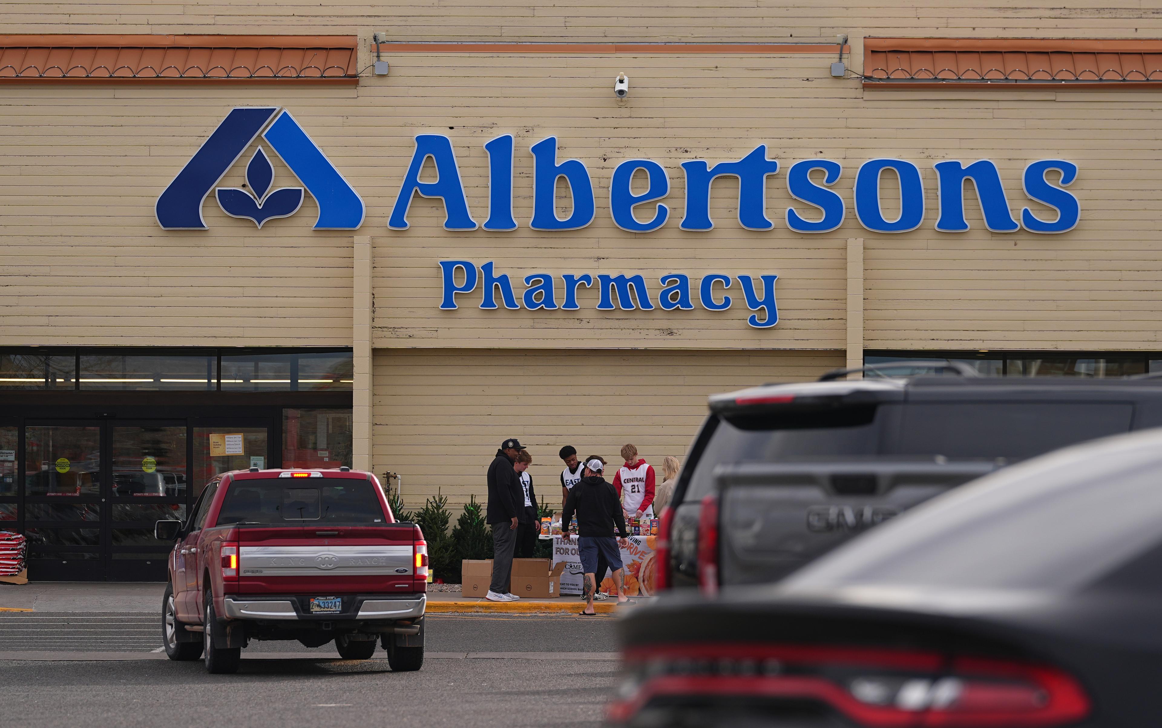 Shoppers head into an Albertson's grocery