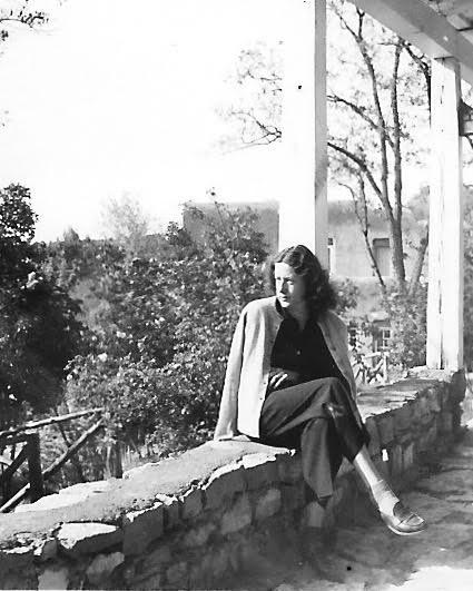 a black and white photo sitting on a stone wall on a porch