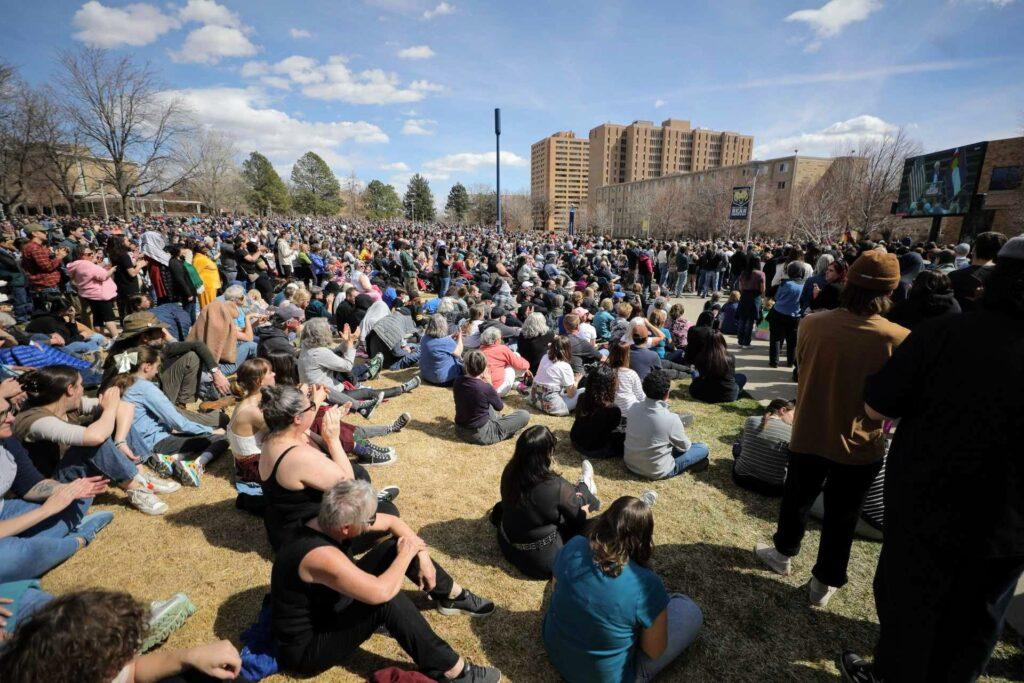 A large overflow crowd on the lawn of the Bank of Colorado Arena in Greeley, watching Sen. Bernie Sanders and Rep. Alexandria Ocasio-Cortez on a large screen