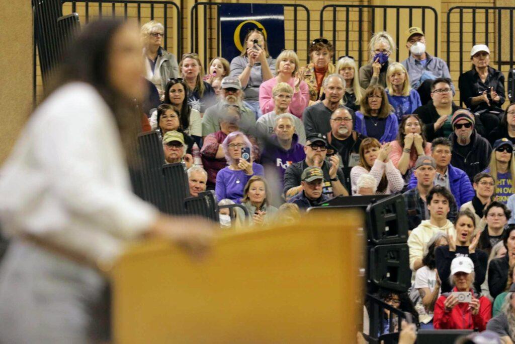 Alexandria Ocasio-Cortez speaks from a podium at the Bank of Colorado Arena in Greeley