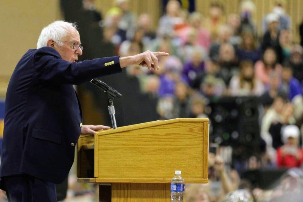 Bernie Sanders speaks from a podium at the Bank of Colorado Arena in Greeley