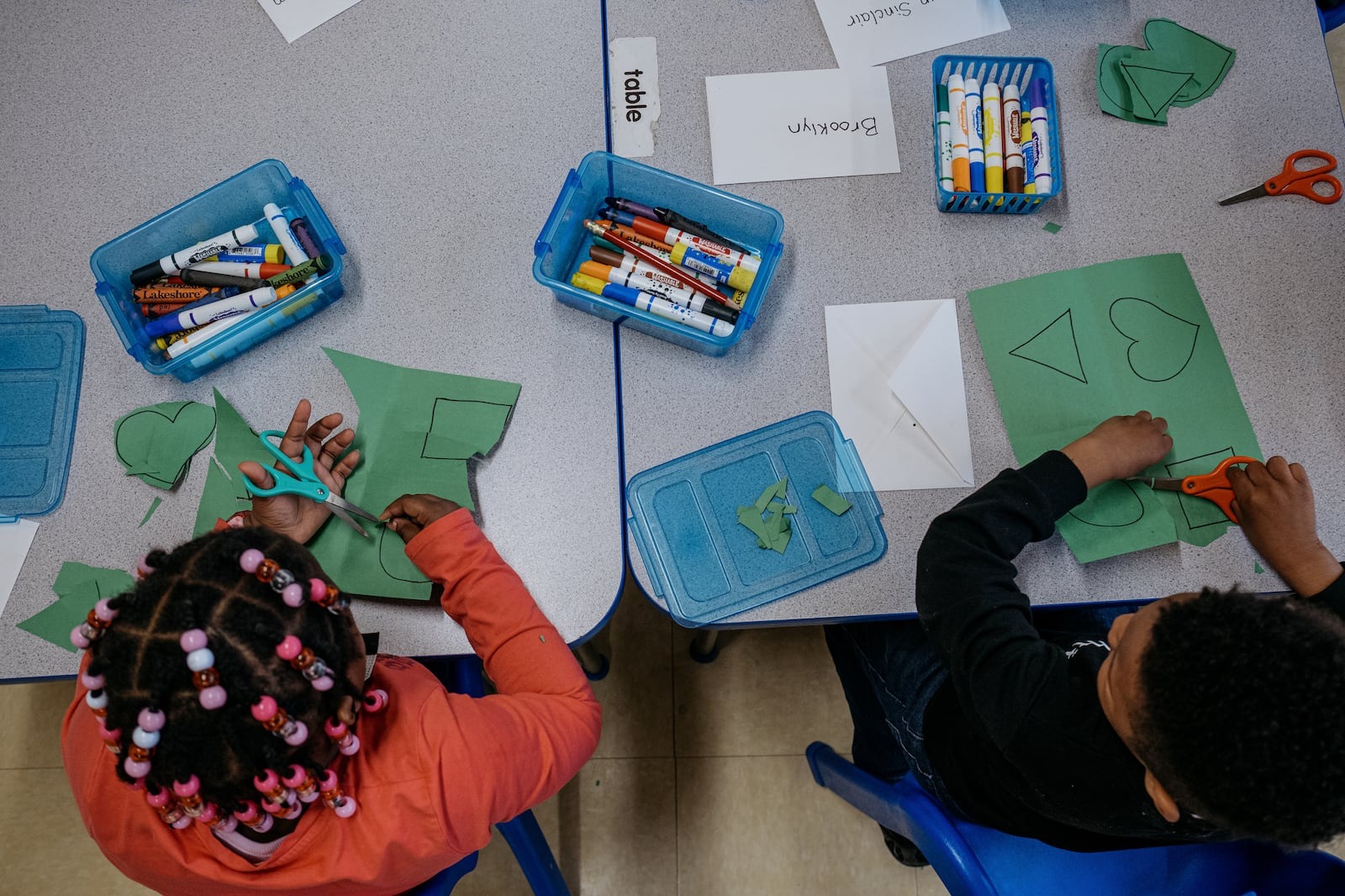 Two children at a table doing arts and crafts