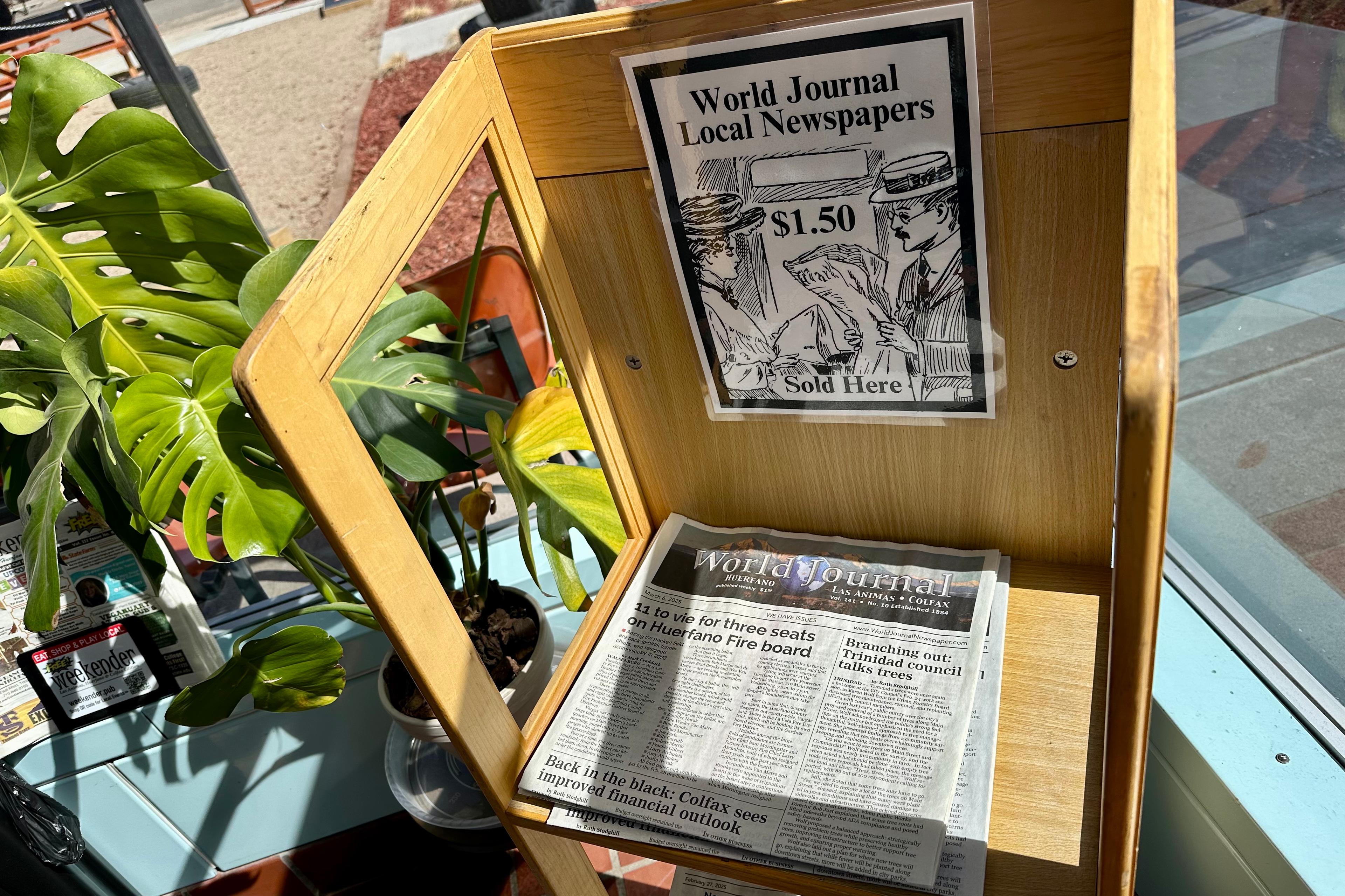 A wooden newsstand sells copies of the World Journal for $1.50